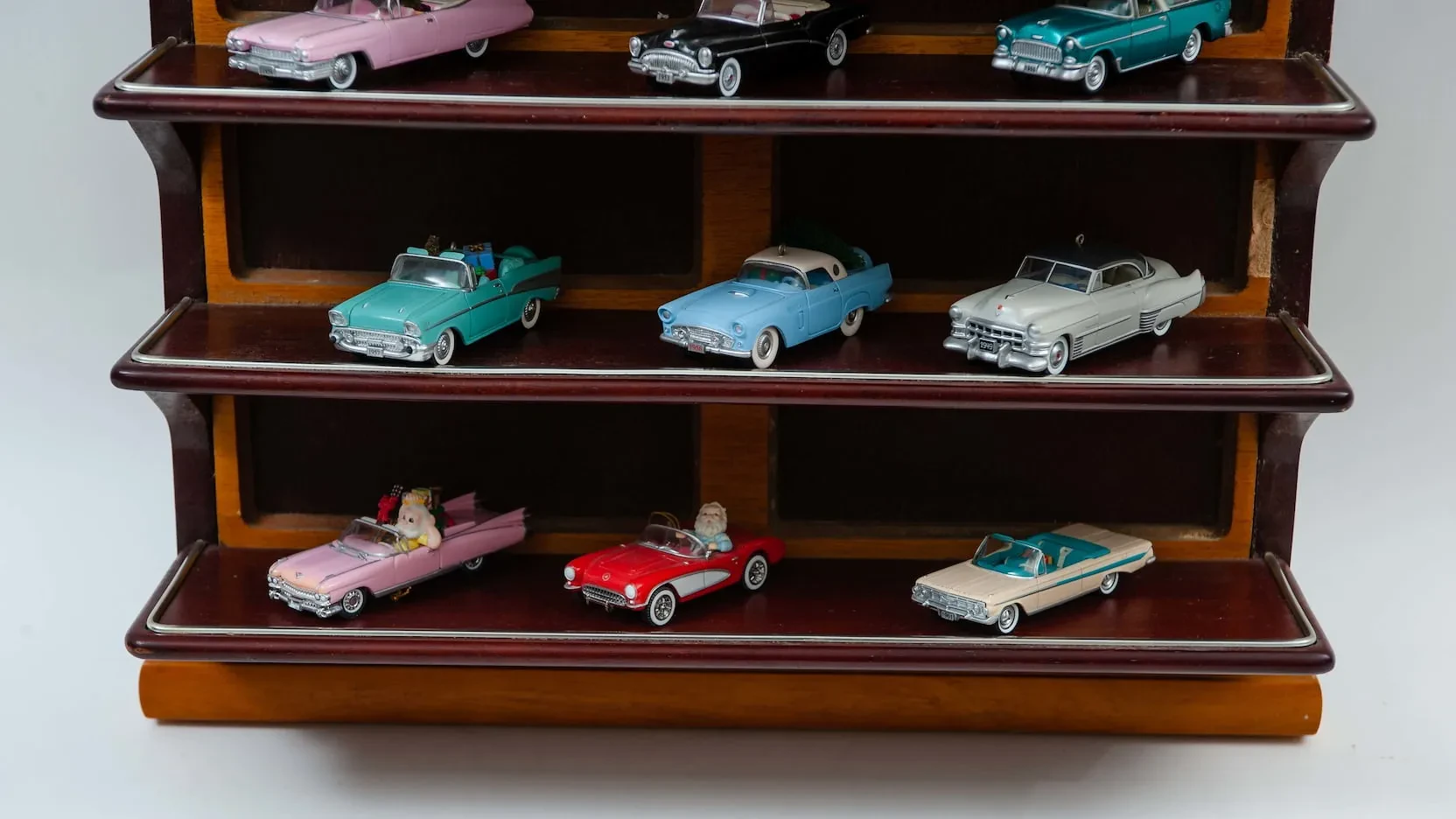 Diecast cars in wooden display case
