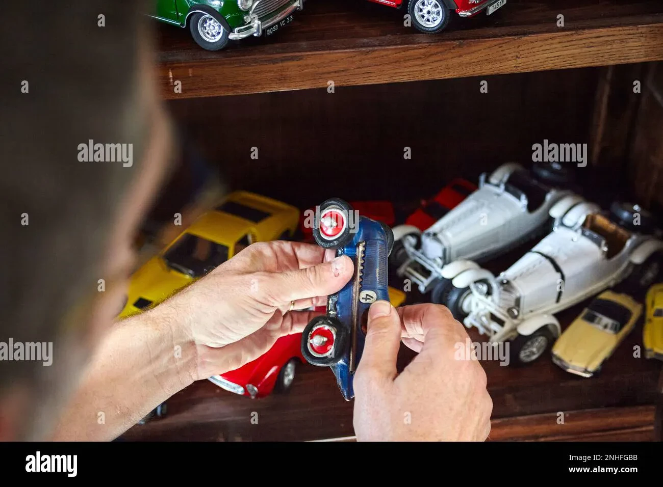 Person admiring diecast car collection